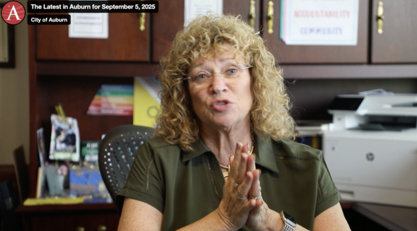 Mayor Nancy Backus talking to the camera seated at a desk