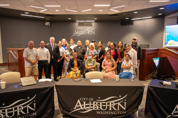 Large group photo of attendees gathered in Auburn City Hall council chambers.