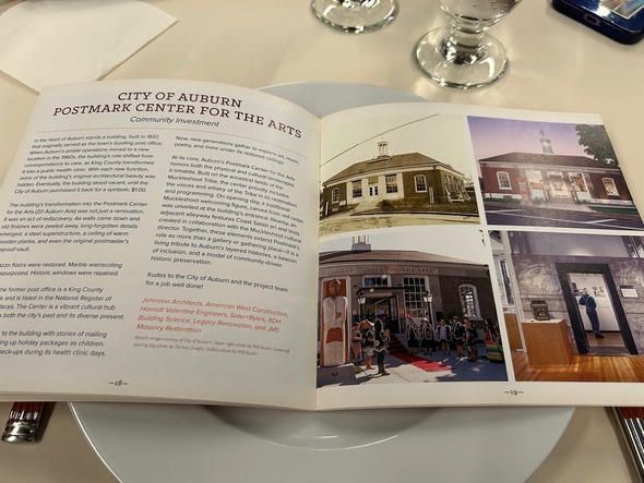 Open magazine spread featuring Postmark Center for the Arts history and renovation with interior and exterior photos.