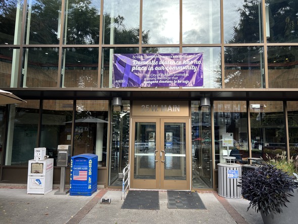 Purple banner on Auburn City Hall reads “Domestic violence has no place in our community.”