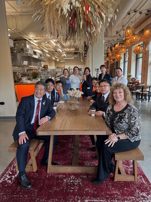 Auburn and Tamba delegates share coffee and conversation inside a local cafe.