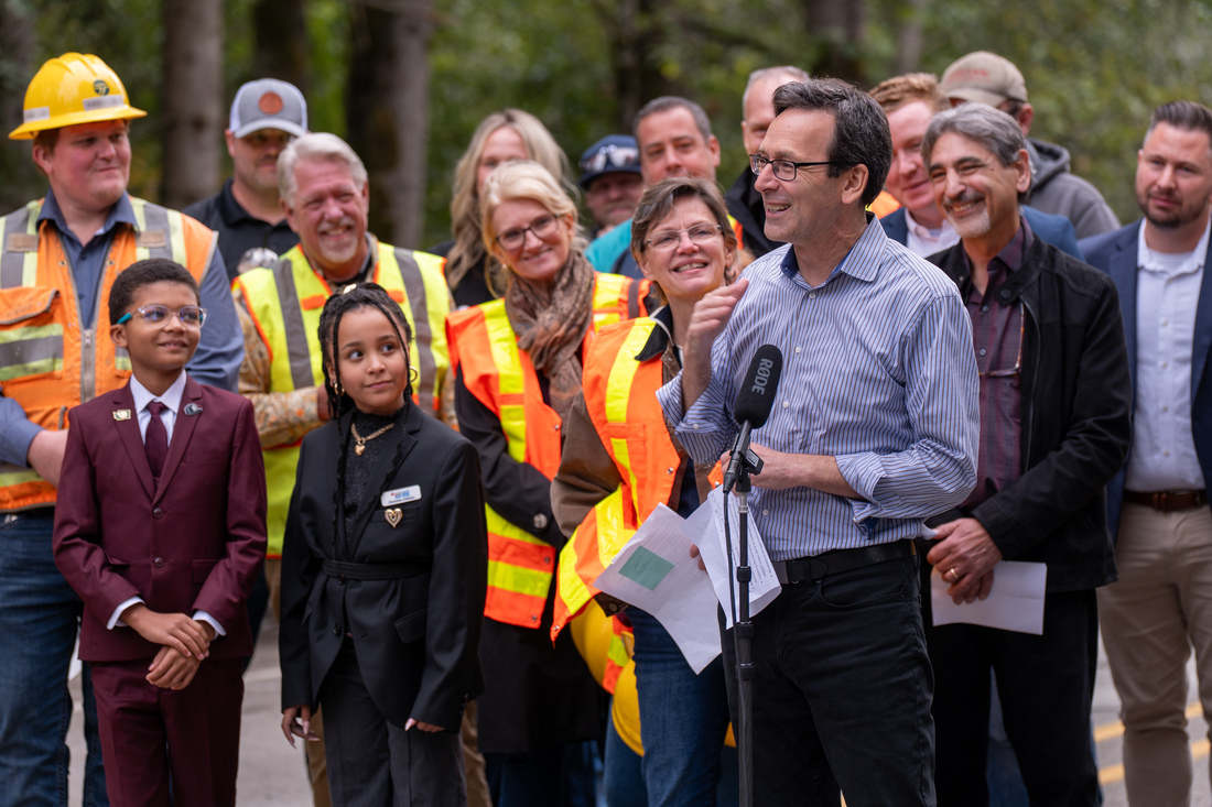A group of people standing at a press conference 
