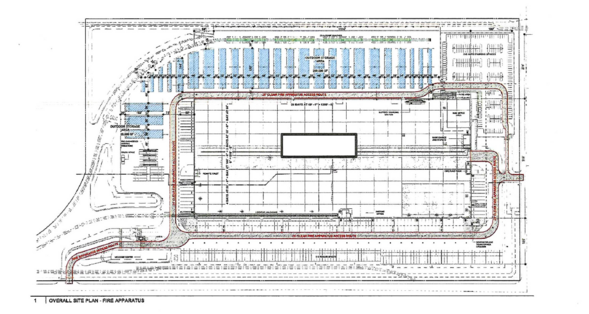 Site plan showing fire apparatus access routes outlined in red around a large warehouse with parking and outdoor storage areas.