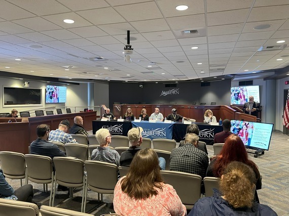 Residents and officials attend a community panel discussion inside Auburn’s Council Chambers.