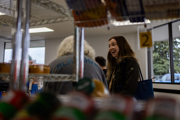 Woman standing near food bank shelves