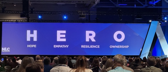A banner that says HERO at a conference