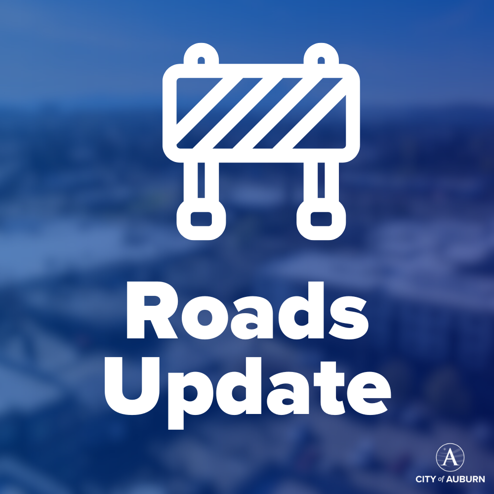 Graphic with road barricade icon and text reading “Roads Update” from the City of Auburn.