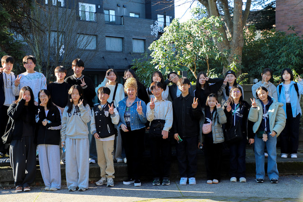 A large group photo of a bunch of students and mayor Nancy Backus doing a peace sign at the camera 