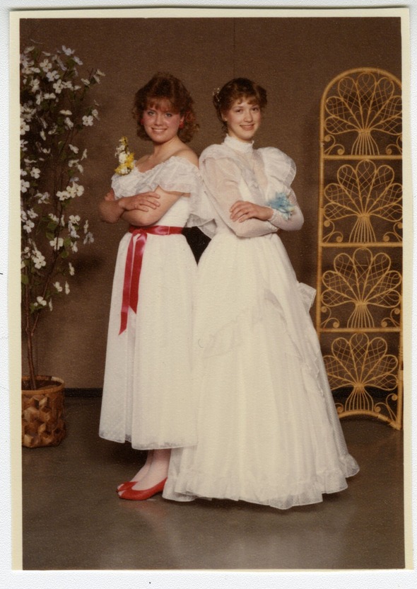 Kelly and Michelle Cavanaugh of Auburn posing together in white formal dresses, 1985