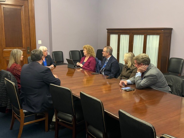 Auburn representatives sit around a conference table in discussion during a legislative meeting in Washington, D.C.