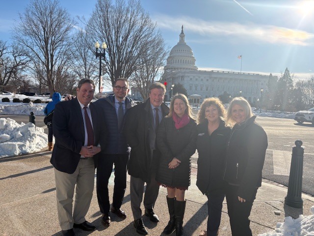Auburn leaders stand outside the U.S. Capitol on a snowy day during advocacy meetings in Washington, D.C.