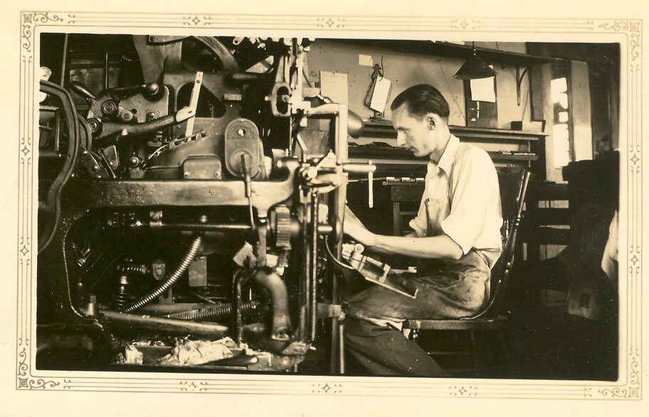 George Kinkade seated at a linotype machine at the Auburn Globe-Republican newspaper.