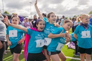 photo of girls running and celebrating during a running event