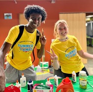 two summer camp leaders offering a craft project