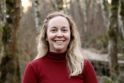 Smiling woman in red turtleneck sweater