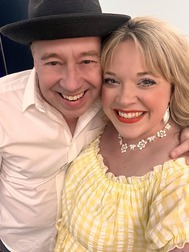 a man and a woman smiling at the camera 