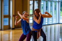 two women enjoying a Zumba class