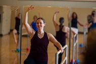 group of people enjoying a barre fitness class