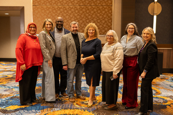 Mayor Nancy Backus poses with community members for group photo at State of the City event.