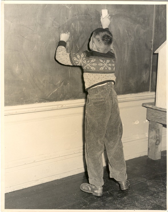 A boy erasing a blackboard 