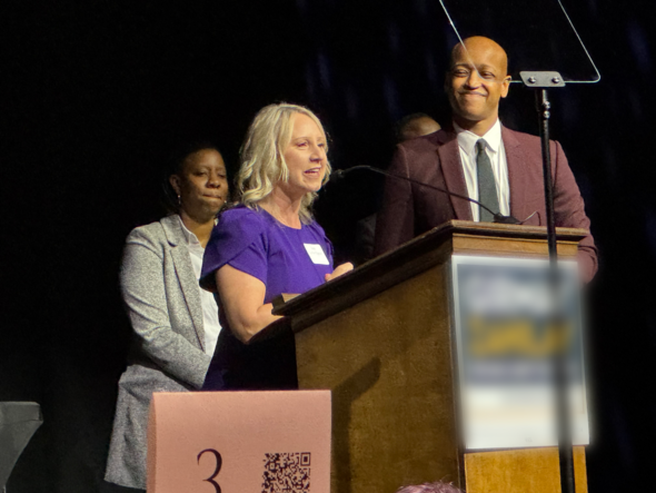 a man and a woman standing at a podium 