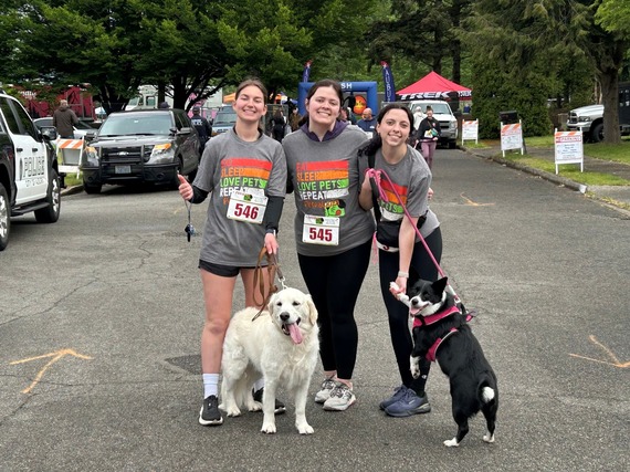 three women and two dogs participating in the Dog Trot 2026 event