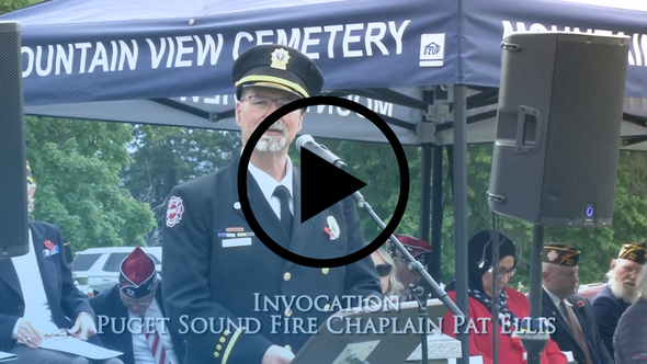 Video thumbnail shows a fire chaplain giving the invocation during a Memorial Day ceremony.