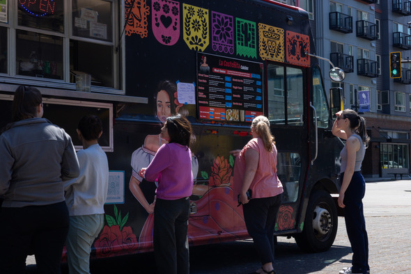 Customers line up at a colorful Mexican food truck on West Main Street in downtown Auburn.