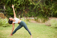a woman doing yoga in a garden 