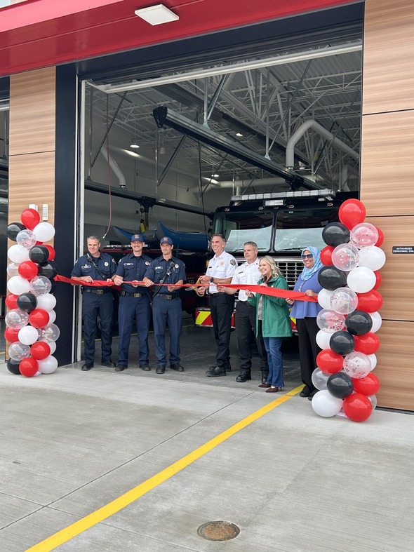 Firefighters and local officials cut a red ribbon in front of Engine 336 at the new VRFA station.