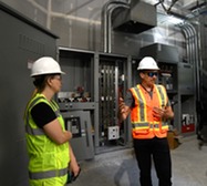 Staff in safety gear inside building under construction