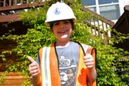 Photo of child in hardhat and safety vest