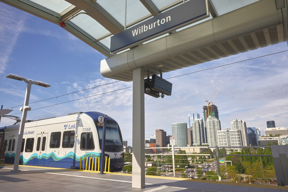 Photo by Stanton J Stephens. SoundTransit Link 2 line train at Wilburton Station. Downtown Bellevue is visible in the background.