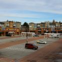Photo shows commercial space with parking lot in front that has some empty stalls.