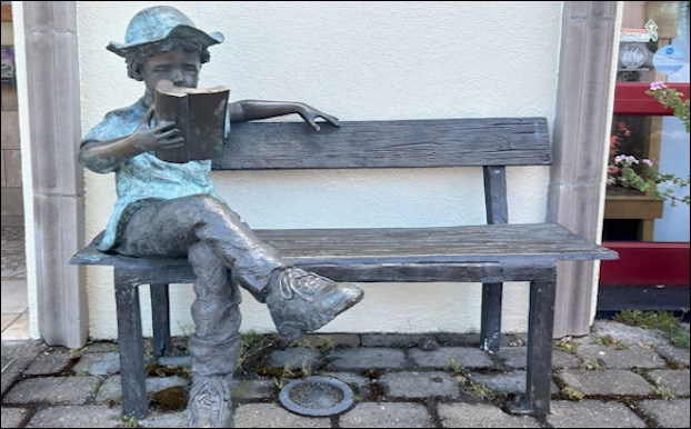 child on a bench sculpture