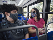 People riding the bus in masks