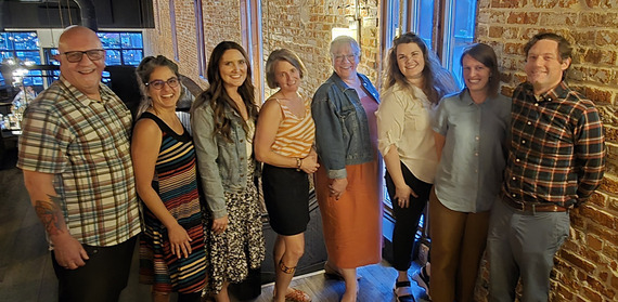 A group of community development managers pose for a photo