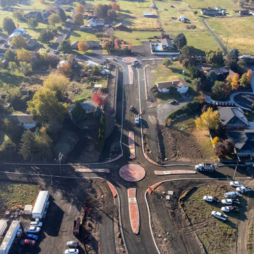 Roundabouts and roadway under construction at the south end of Myra Road at Taumarson and Highland roads