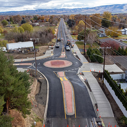 New roundabout at the intersection of Taumarson Road and Myra Road, looking east down Taumarson with foothills in the distance