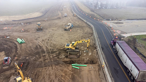 Aerial view of the SR 125-Myra Road intersection, with the highway reduced to two lanes while construction work goes on to the south