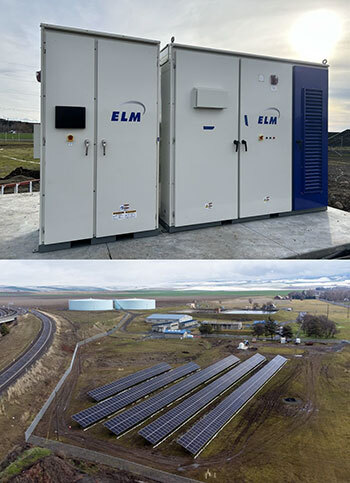 Large metal cabinets holding solar batteries, and a solar array