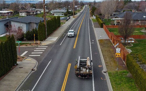A speed feedback sign shows a vehicle traveling 33 mph in a 35 mph zone on Taumarson Road