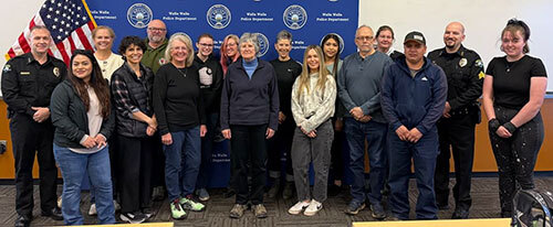 Group of 17 people including two police personnel stand for a photo