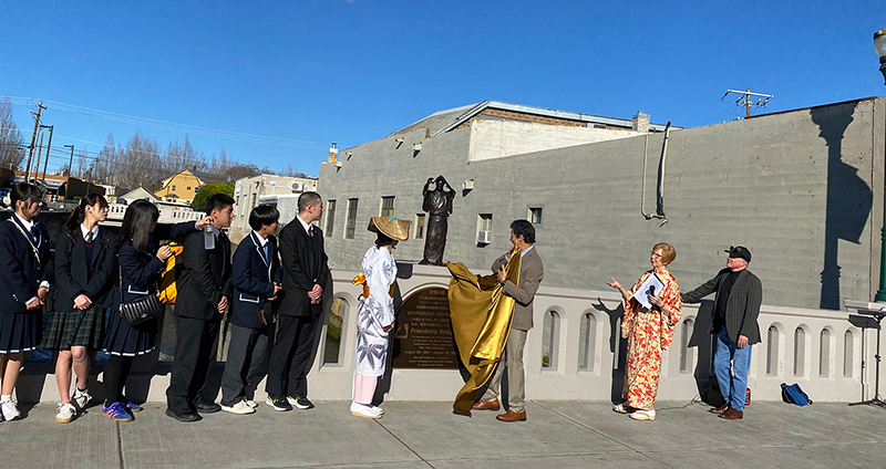 Japanese students, a consul, Mayor Gustavo Reyna, and two Walla Walla residents look at a statue of a dancer after its unveiling