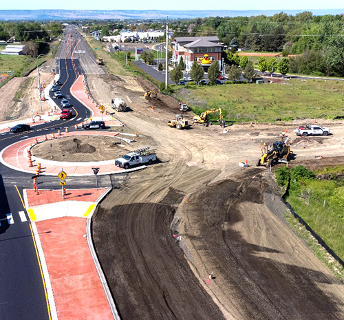 Roundabout under construction at Myra Road and State Route 125; the center islands and south half are finished but the rest is dirt