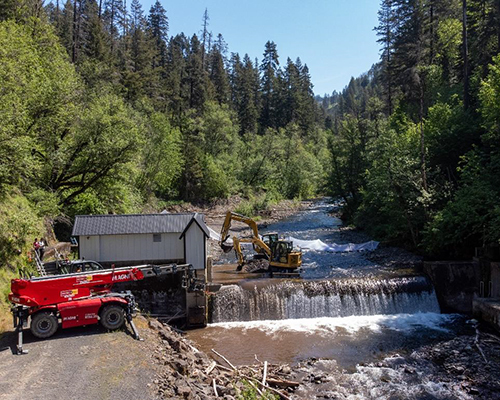 Excavators remove debris from Mill Creek next to the City's intake facility