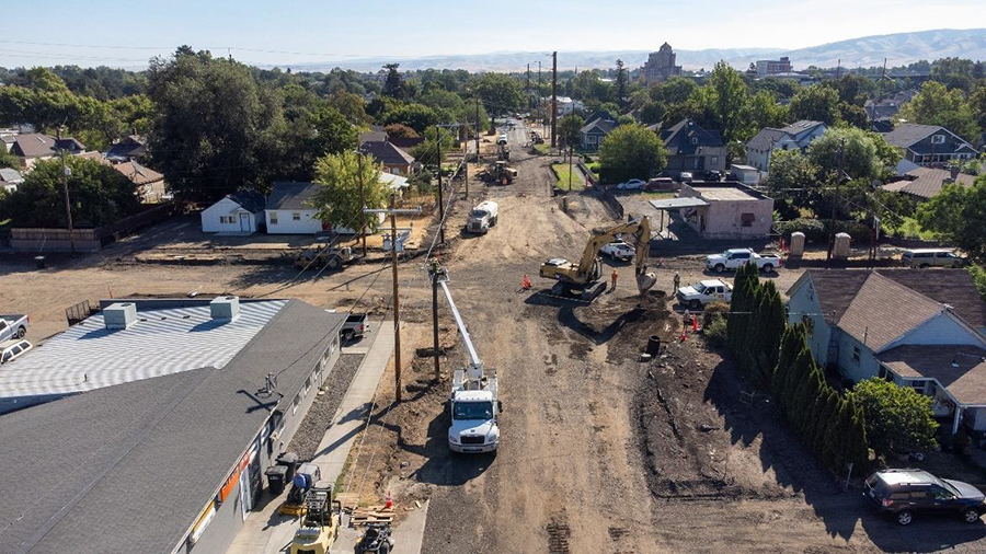 Vehicles, equipment, and crew members work around the 9th-Pine intersection, which has been stripped of asphalt