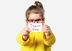 Child holding a thank you note