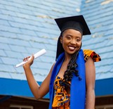 graduate holding diploma