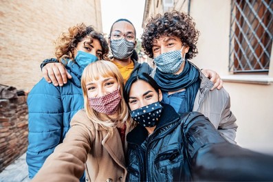 Youth gather together wearing facemasks